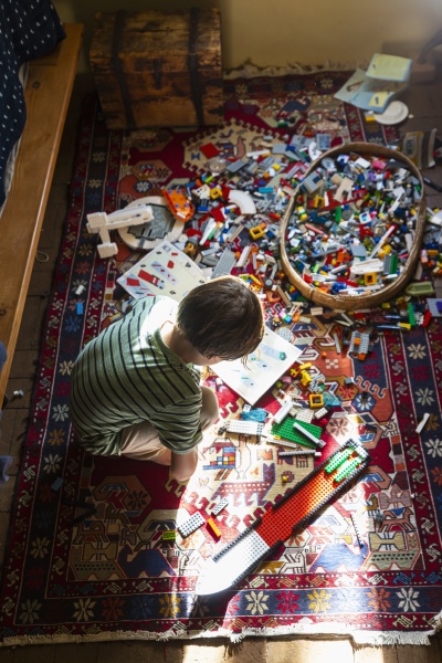 boy, sitting, among, toys, on, his - 30677319